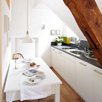 Narrow kitchen in the attic of a country house