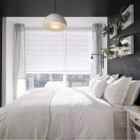 White bed in a room with gray walls