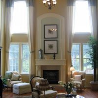 Tall living room windows with long curtains