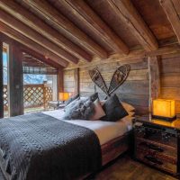 Wooden bed in the bedroom of a private house
