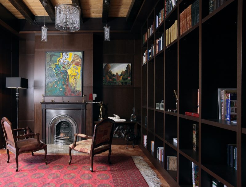 Book shelves in a room with a fireplace