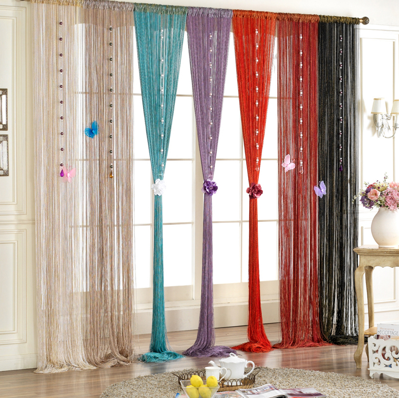 Multi-colored filament curtains on the hall window