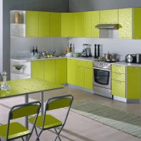 Corner kitchen with green facades