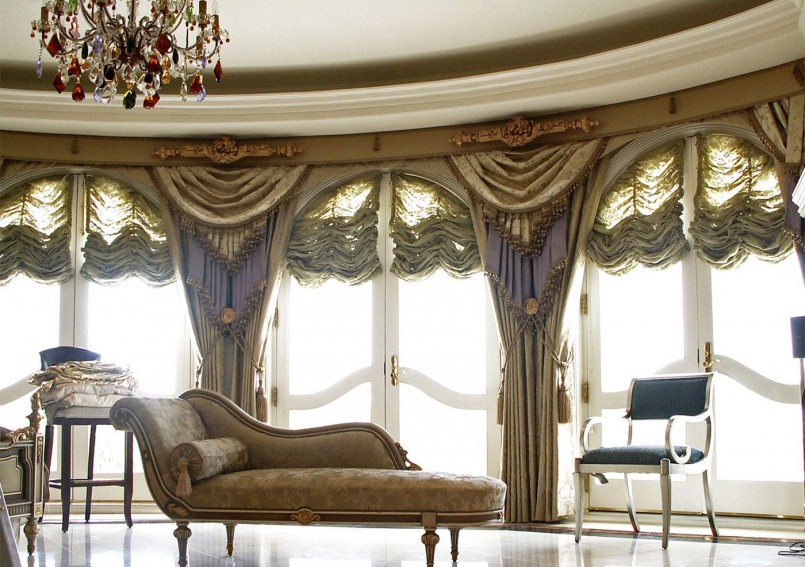 The combination of fabric on the curtains and decoration of upholstered furniture in the living room