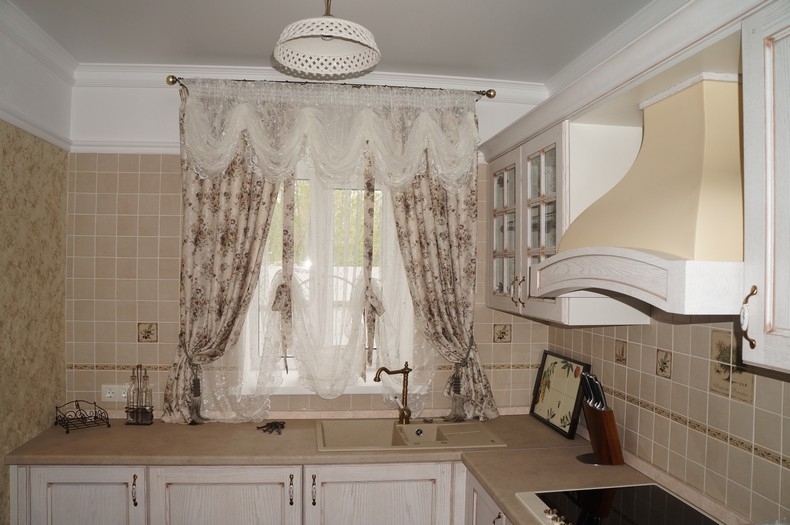 Short curtains on the sink with a vintage faucet