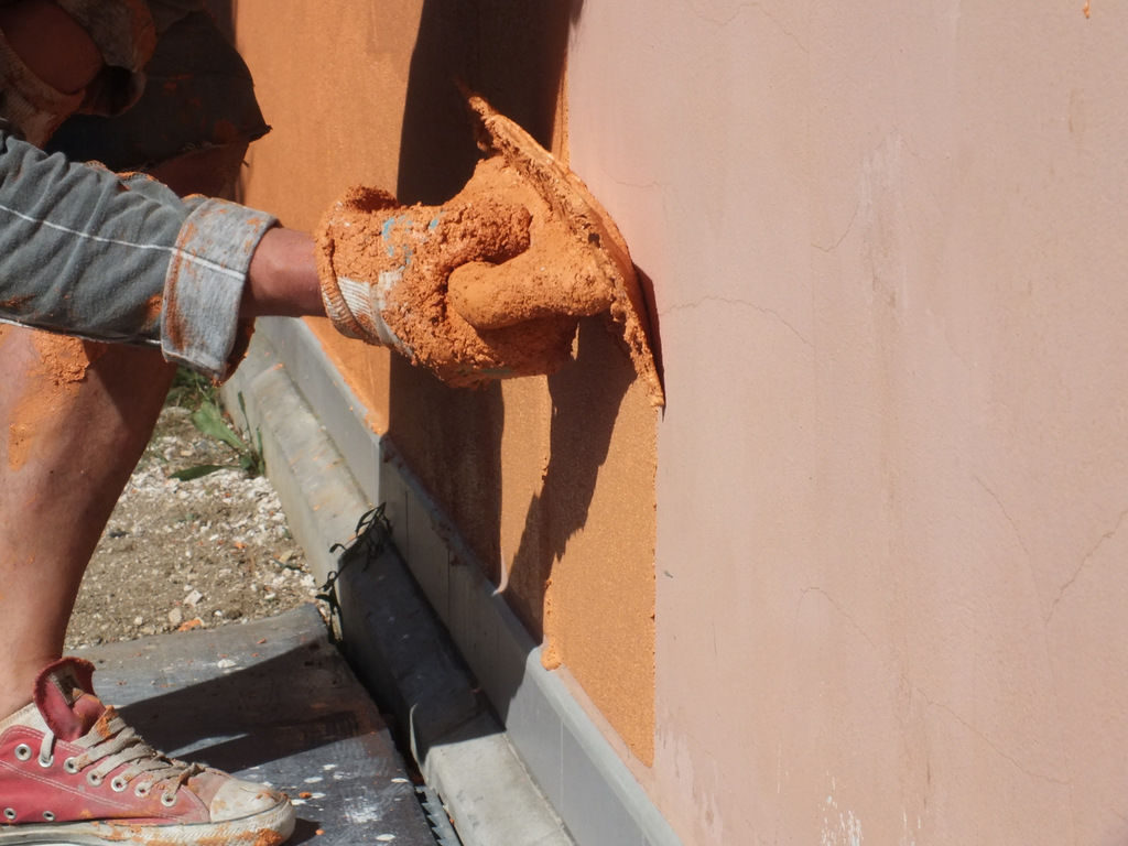 Application of decorative plaster on the facade of the house