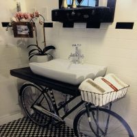 Washbasin from an old bicycle in the bathroom