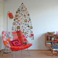 Christmas tree of souvenirs and badges on a white wall