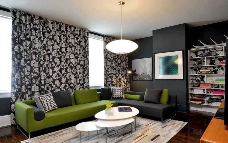 Green sofa in a room with dark walls