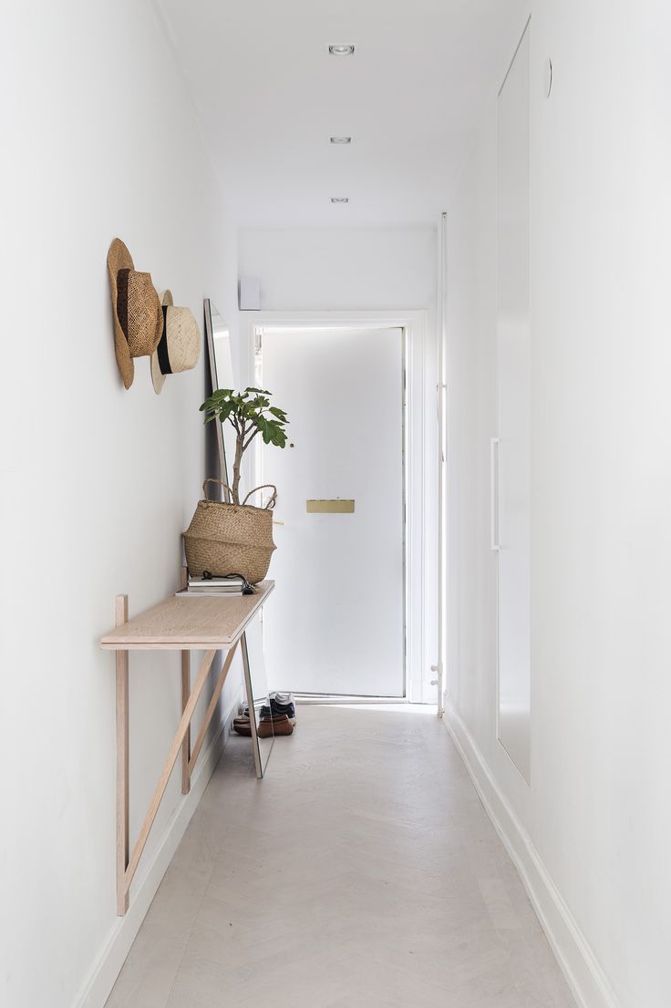 White entrance hall with a minimum of furniture and accessories