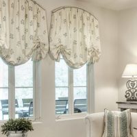 Curtains on the arched windows of the living room in a rural house