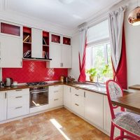 Red curtains in the design of the kitchen