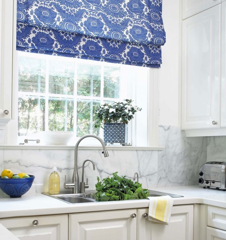 Blue roman curtain over the kitchen sink