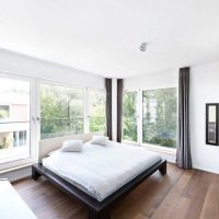Bright bedroom interior with panoramic windows