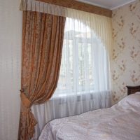 Asymmetric Italian curtain on the bedroom window