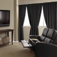 Black curtains in the room with massage chair.