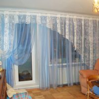 Transparent tulle curtains in the room with a balcony