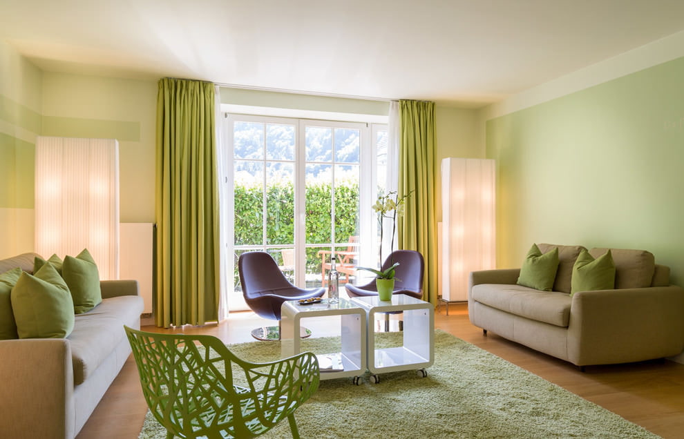 Pareti verde pallido nel soggiorno con due divani