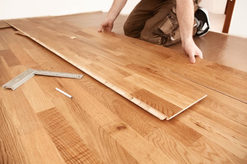 Laying parquet board on the floor of the living room