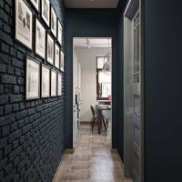 The brick wall of the corridor is dark gray