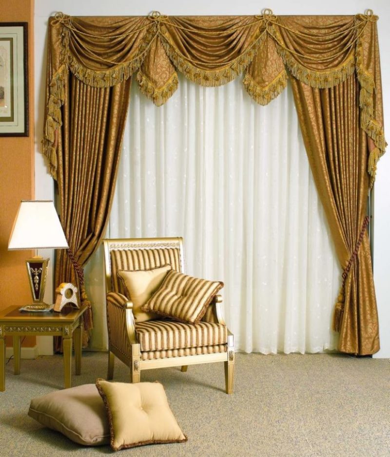 Golden curtains with a lambrequin on the living room window