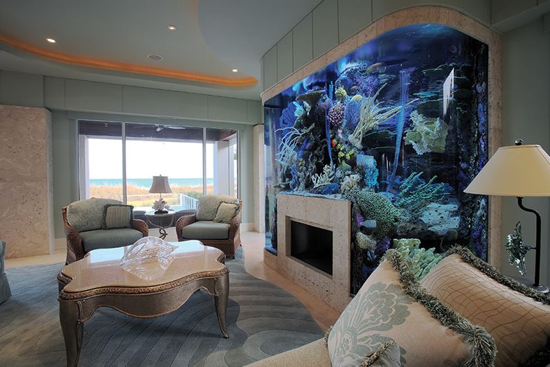 Fireplace and aquarium in the spacious living room interior