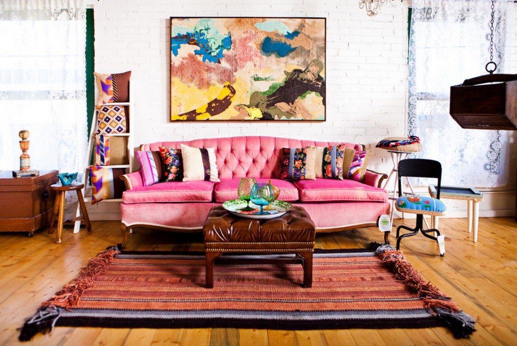Pink sofa in boho style cottage room