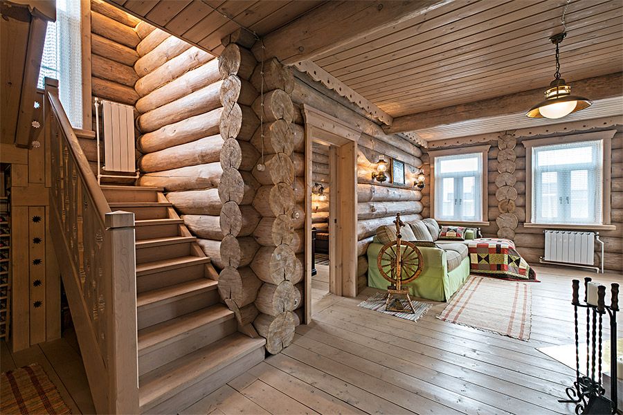 Wooden staircase in the living room of a log house