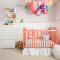 Colorful balloons over a baby crib