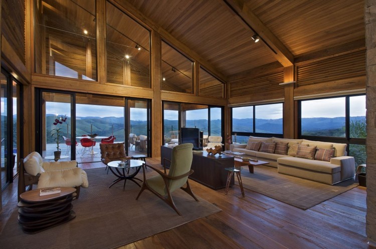 Design of a living room of a wooden house with panoramic windows