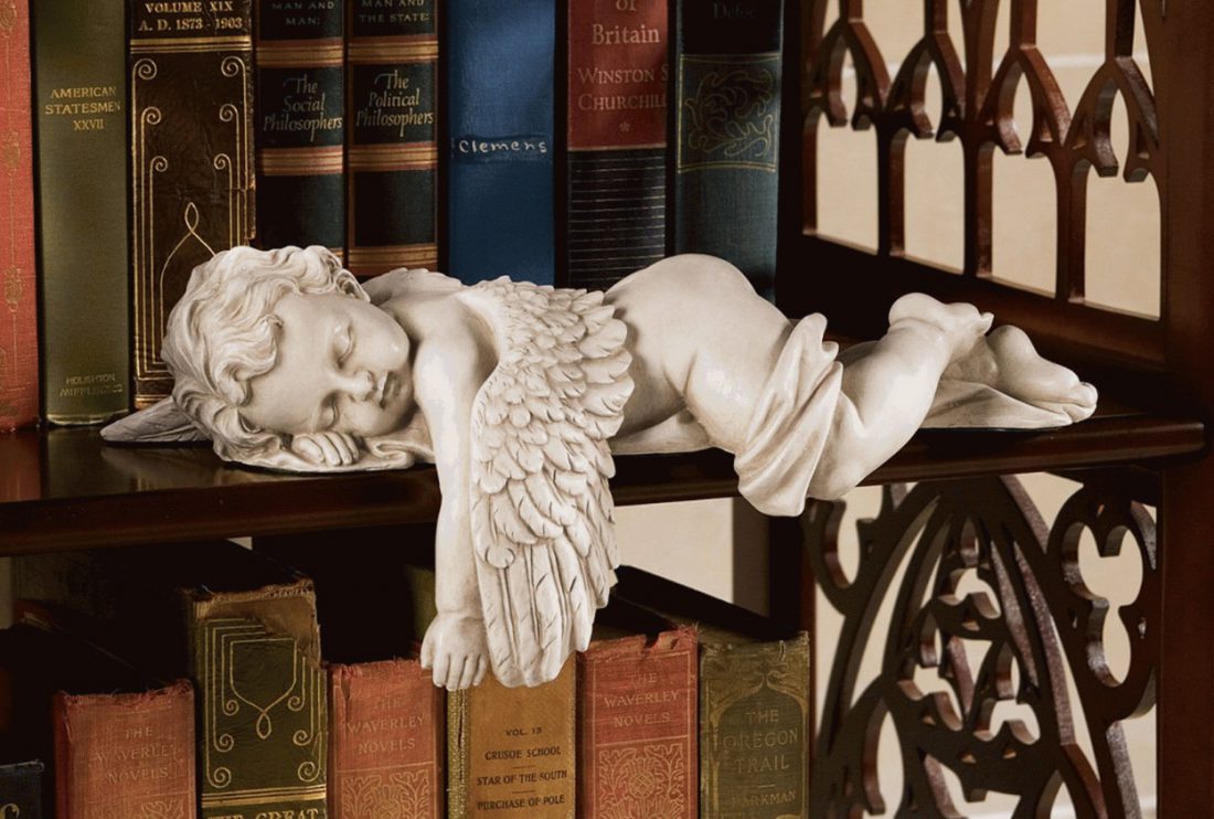 Angel figurine on bookshelf