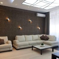 Beige sofa in the room with brown wallpaper