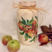 Red-green apples on the table and on the jar