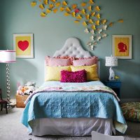A flock of paper butterflies on the wall in a bedroom