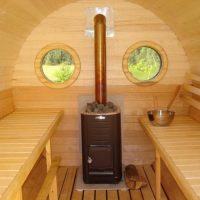 Steam room with a stove in a barrel bath