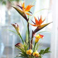 Glass cup with artificial flowers