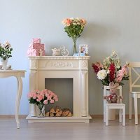 Fireplace decor with artificial flowers.