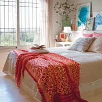 Bright bedspread on a white bed