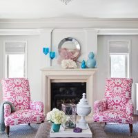 Bright armchairs near the fireplace in the living room