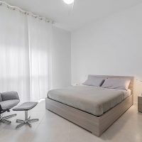 Light curtains in a white bedroom