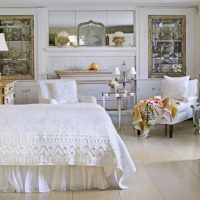 Bed with a white bedspread in a spacious bedroom