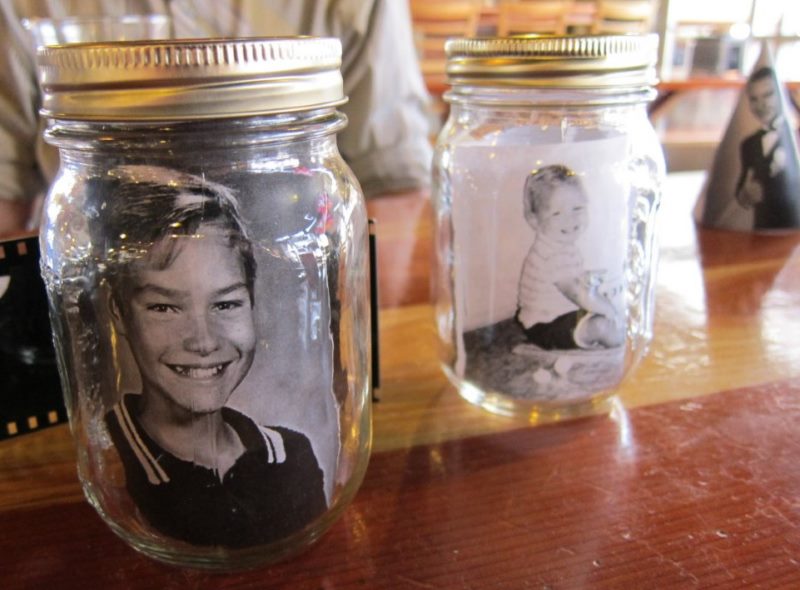 Black and white photographs inside glass jars