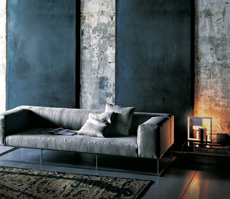 Gray sofa near the graphite walls of the living room