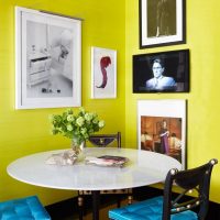 Dining table in the corner between the yellow walls
