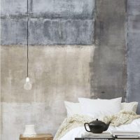 White bed on a gray concrete wall background