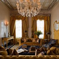 Golden curtains in the interior of the hall of a country house