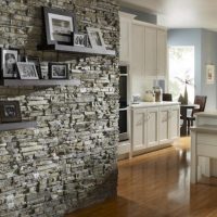 Shelves with photos on the wall with stone cladding