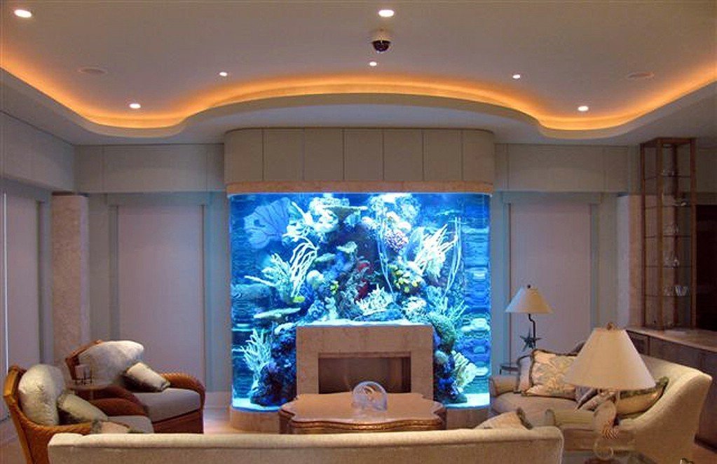 Fireplace with an aquarium in the interior of the living room of a country house