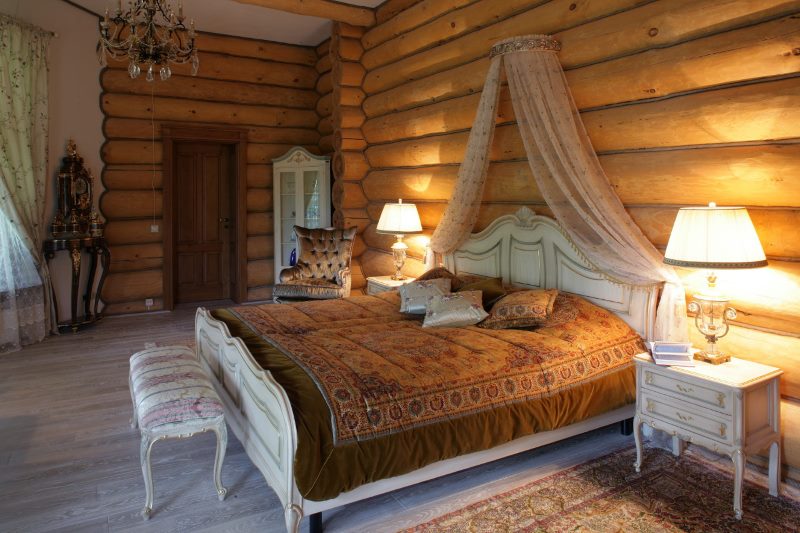 classic furniture in the bedroom of a log house