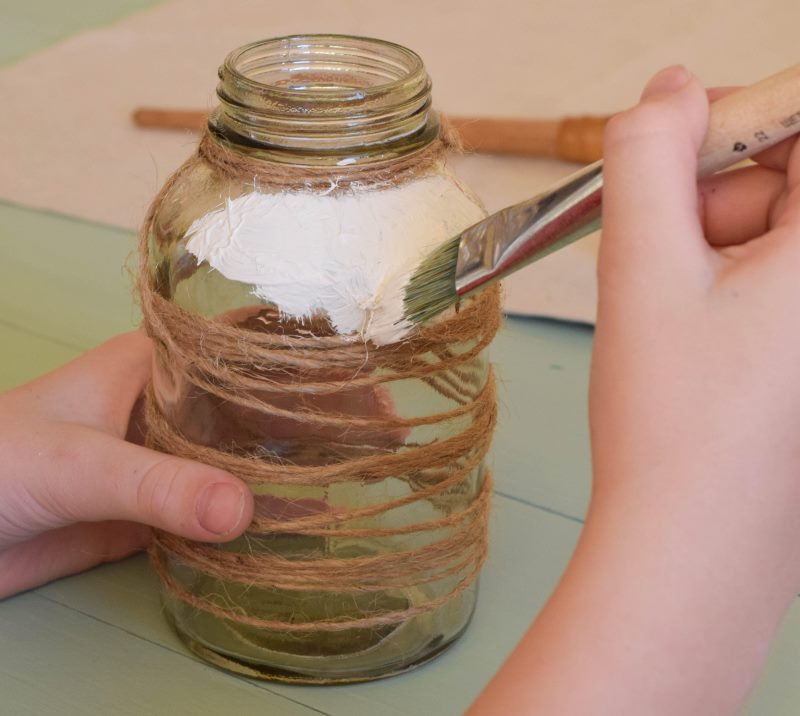 Drawing white paint on a glass jar